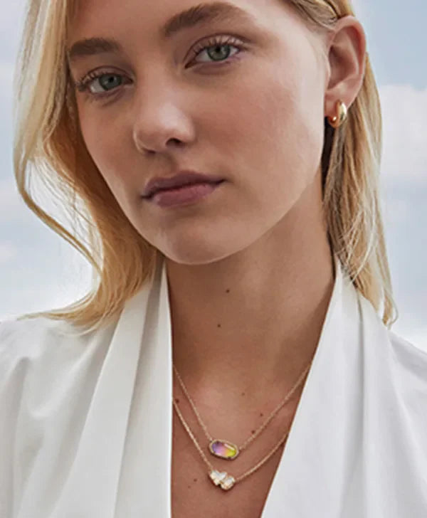 A blonde woman modeling Kendra Scott Necklaces 